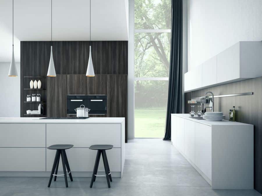 Modern kitchen with white island, black stools, dark wood accents, and pendant lighting.