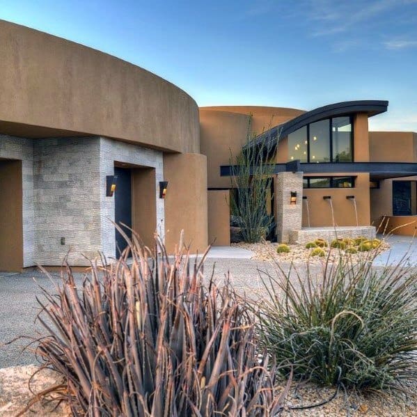 modern desert house with stone garden with plants 