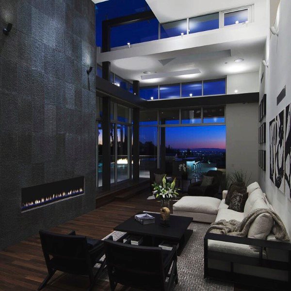 Spacious modern living room with linear fireplace, floor-to-ceiling windows, and city view.