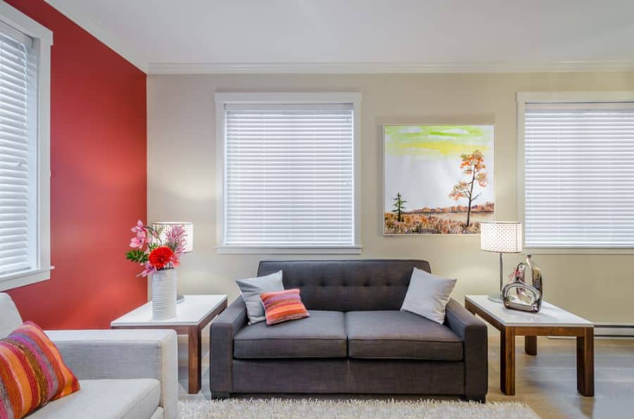 modern family room red accent wall couches two table with lamps