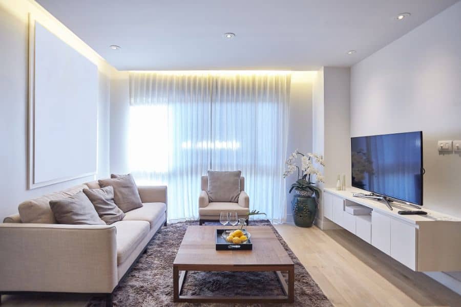 modern family room beige couches floating cabinet tv led ceiling lights