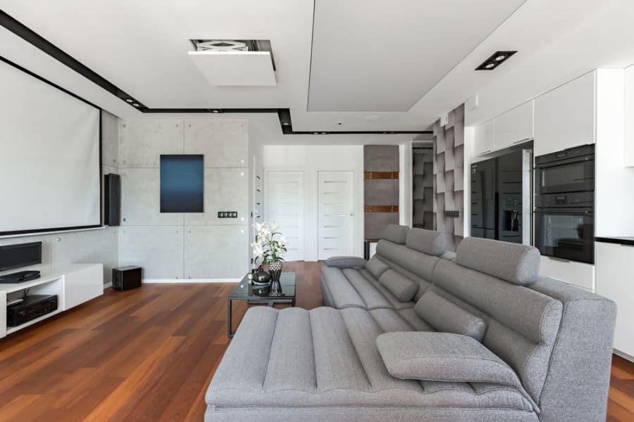 modern kitchen living room gray couch projector tv hardwood floors