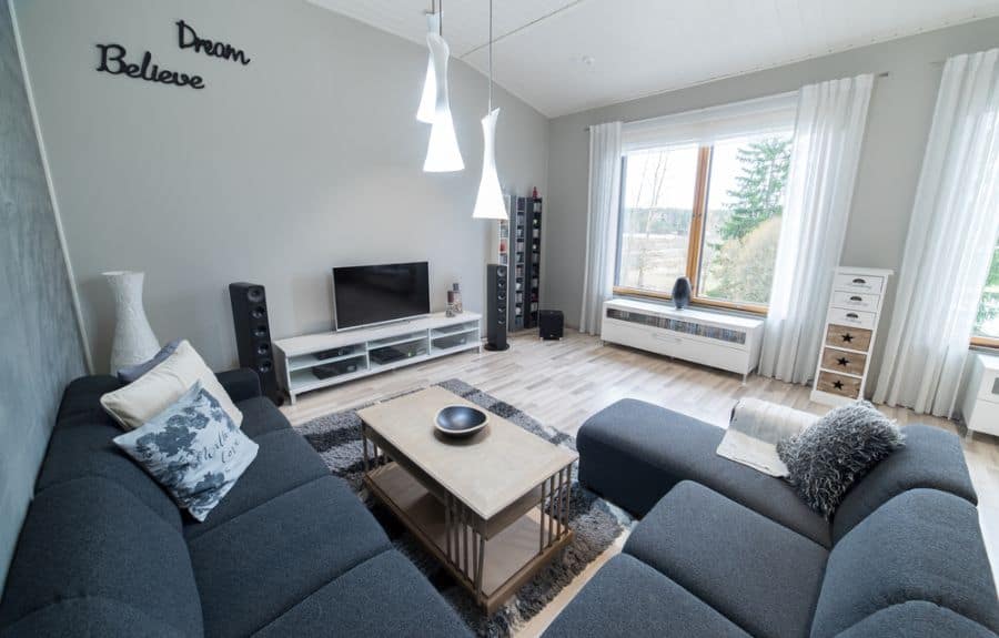 large living room l-shape couch tv stereo system pendant lights