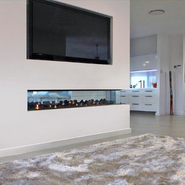 Sleek see-through fireplace with white surround, mounted TV, and open modern interior design.