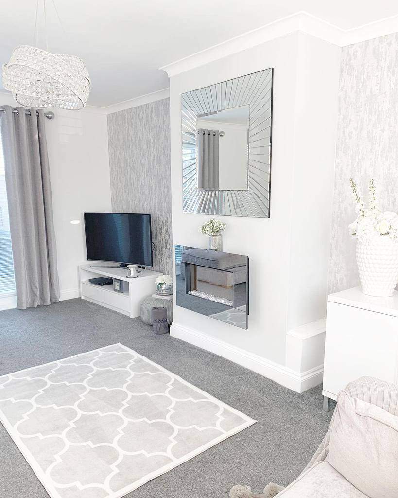 white living room small fireplace wall mirror gray carpet with rug