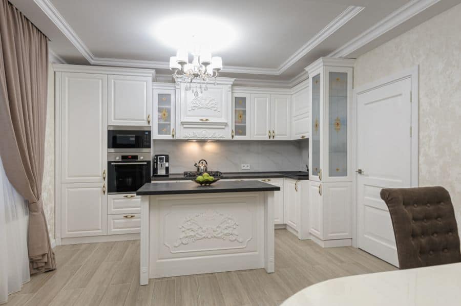 modern white kitchen black countertop chandelier thick curtains 