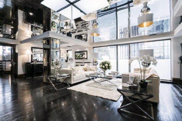 Luxurious modern living room with sleek furniture, glossy floors, large windows, and mirrored ceiling accents