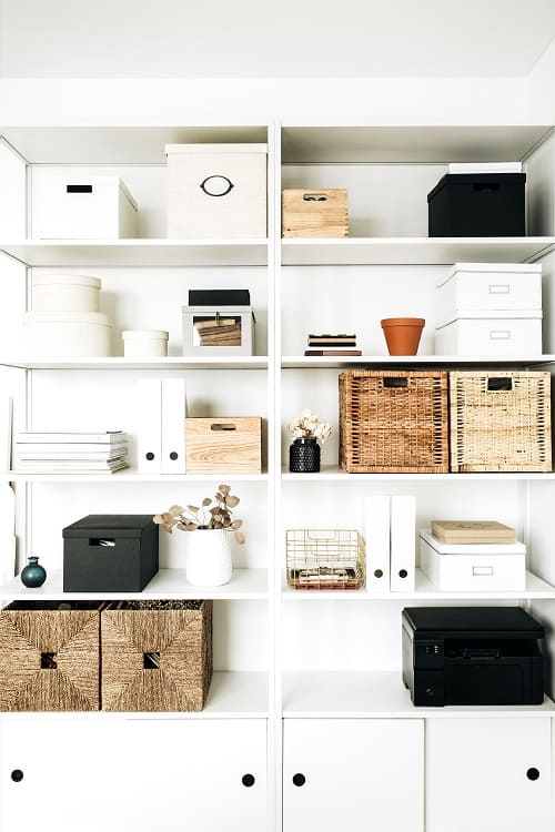 Modern home office shelves with decorative boxes, baskets, and files for organized storage.