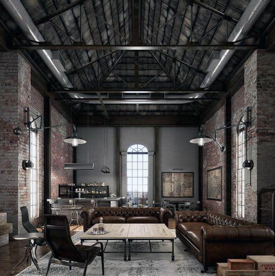 Spacious industrial loft with exposed brick walls, leather sofas, and high vaulted ceilings.
