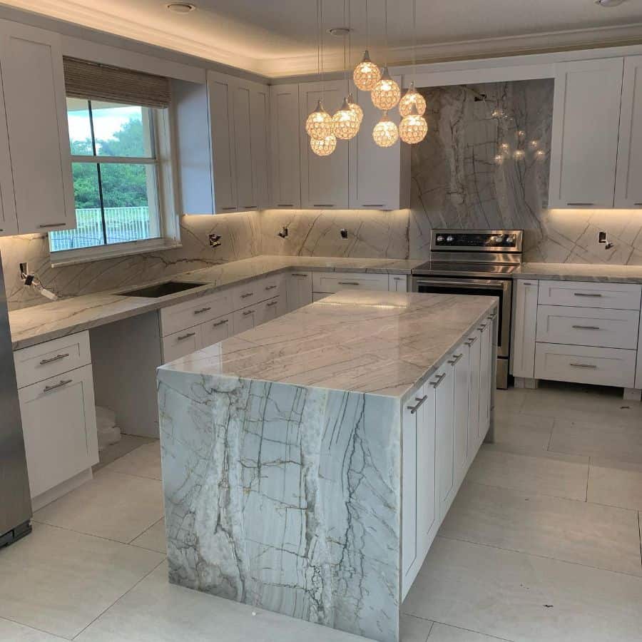 modern white cabinet marble countertop kitchen grouped pendant lights