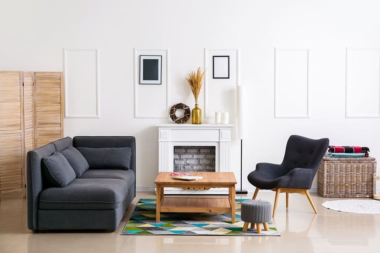 modern living room with white fireplace and blue sofas