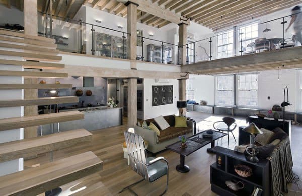 Contemporary loft with open layout, floating stairs, glass railings, and natural light.