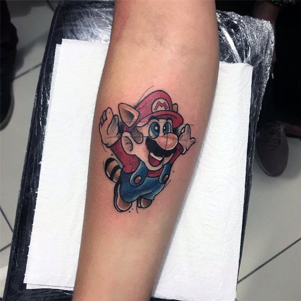 Colorful *Super Mario* tattoo featuring Mario in his Raccoon suit, mid-flight with detailed shading and vibrant tones for a nostalgic gaming look.