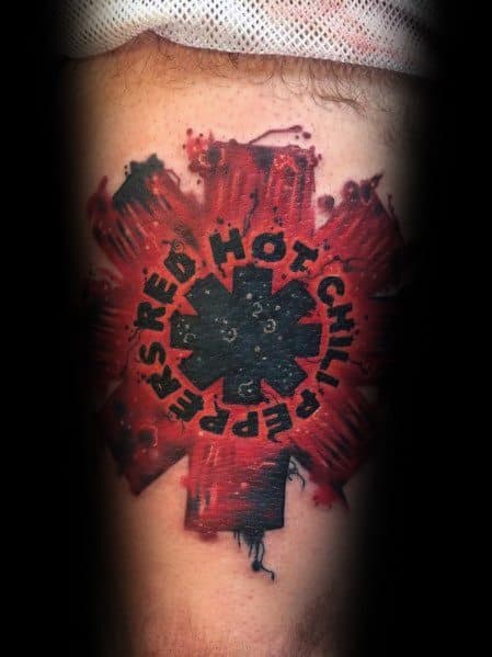 Tattoo featuring the Red Hot Chili Peppers logo with a bold black center, distressed red paint effect, and the band's name circling the emblem.