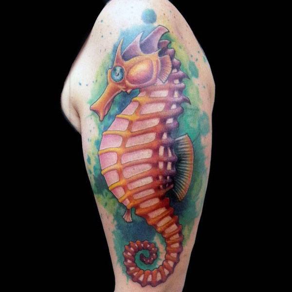 Realistic seahorse tattoo on upper arm, featuring vibrant orange and yellow hues with a green watercolor background for a bold, aquatic look.