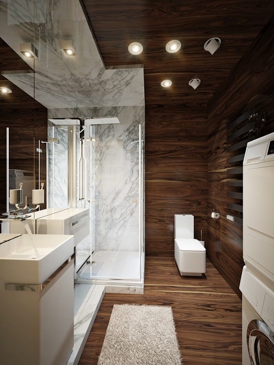 Modern bathroom with wood and marble decor, featuring a ceiling shower, white fixtures, and a plush rug