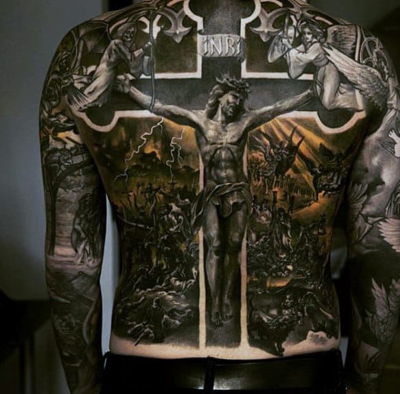 Back tattoo depicting a detailed crucifixion scene with surrounding religious imagery