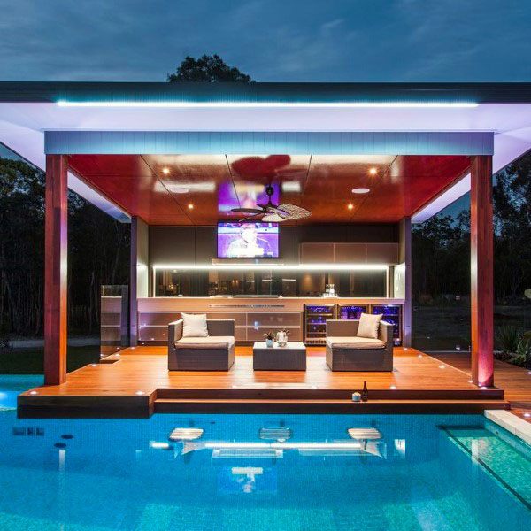 Luxury floating poolside bar with sleek furniture, LED lighting, and a mounted TV.