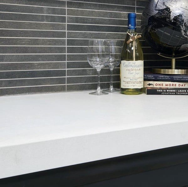 Sleek slate backsplash pairs with a crisp white countertop for a modern touch.