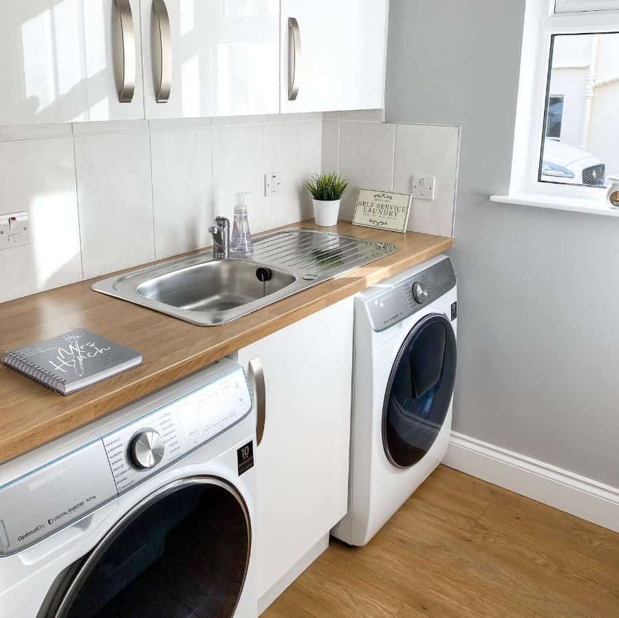 small laundry room with sink and cabinets