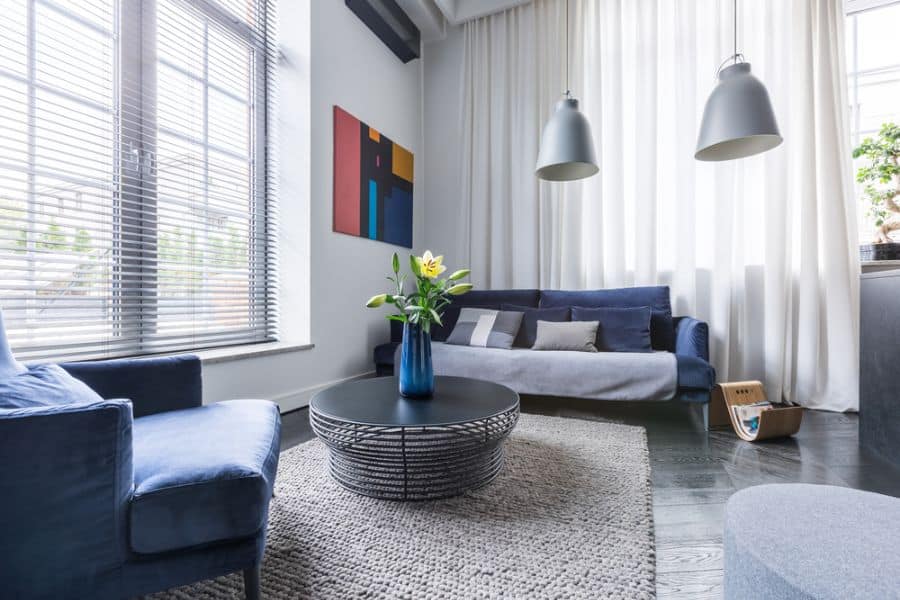 modern living room with blue sofas and thick curtains