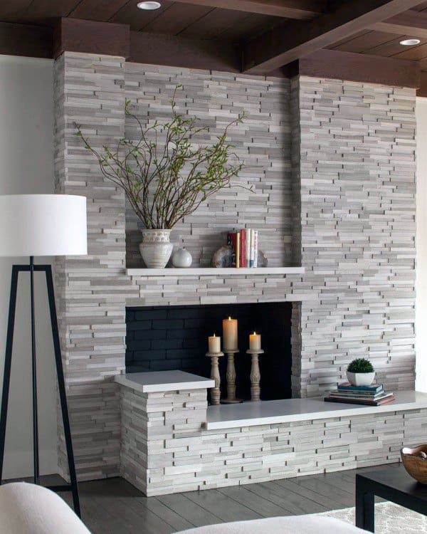 Modern stone fireplace with sleek, horizontal layering and built-in shelving for decor.