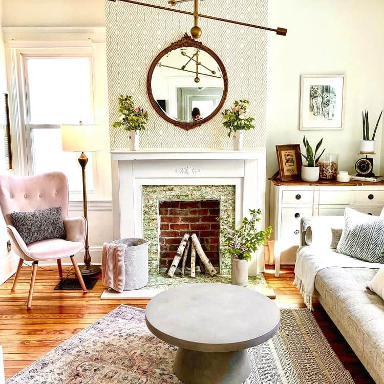 modern vintage living room with pattern wallpaper fireplace and accent pink chair
