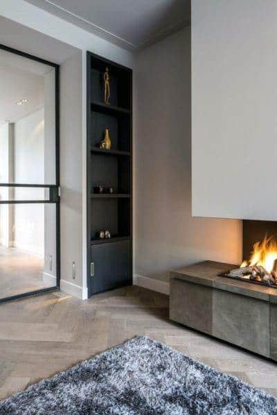 Modern wall fireplace with clean lines, warm tones, and integrated shelving for a cozy, stylish ambiance.