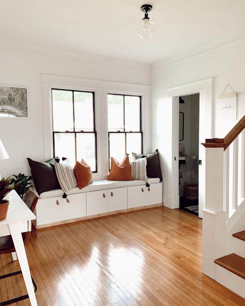country living space window seat with underneath storage wood flooring