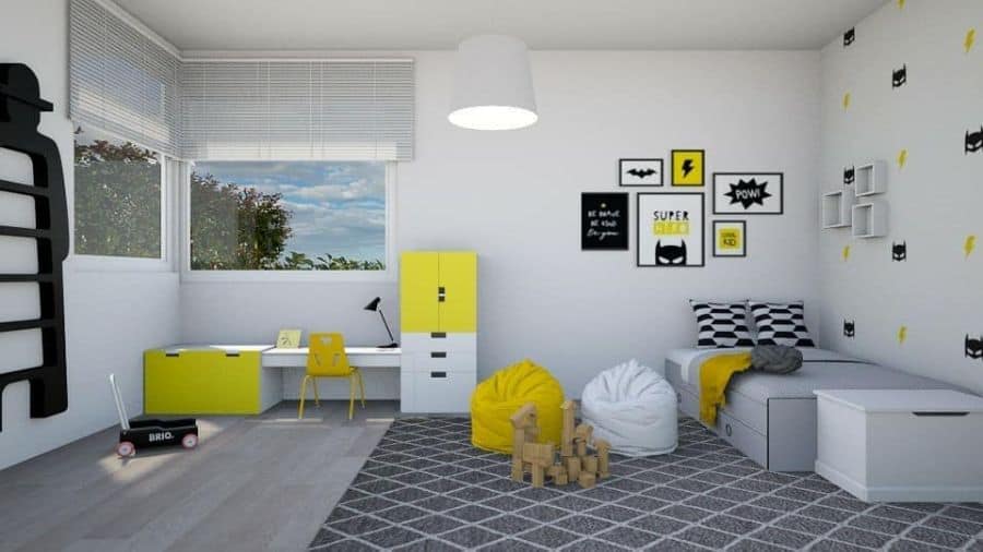 Children's room with a desk, yellow storage, bean bags, and bold superhero-themed wall decor