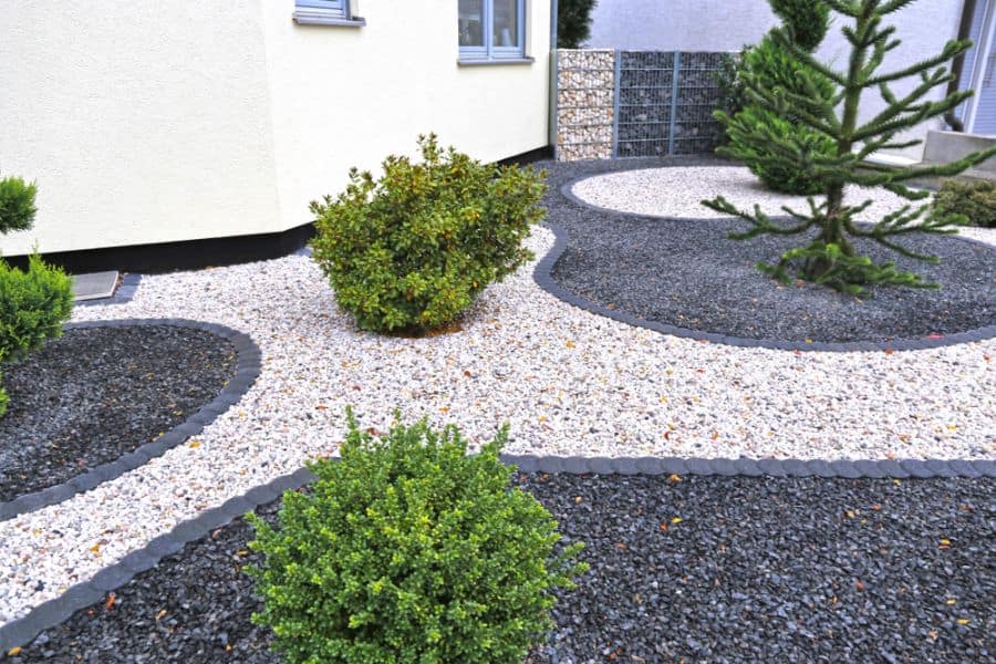 zen garden with white and black stones small shrubs