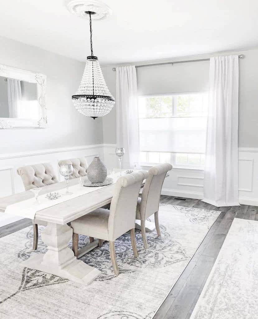 white dining room glass chandelier gray table and chairs wall mirror
