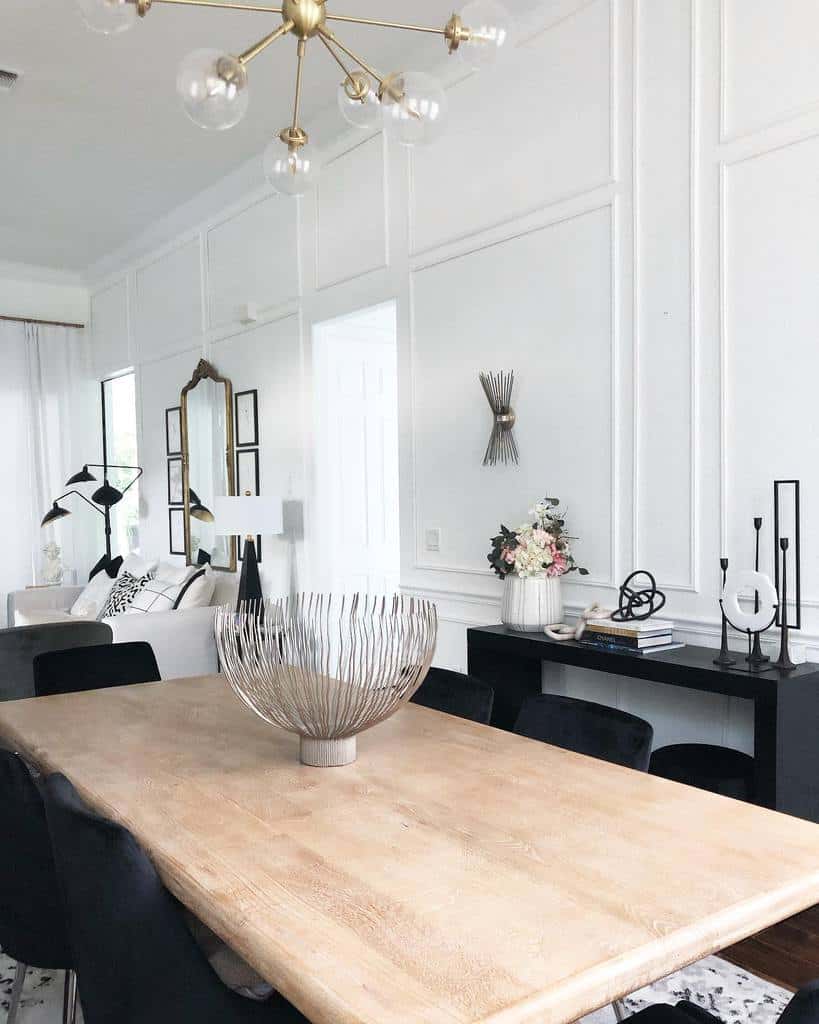 white dining room living room wood table black chairs gold sputnik chandelier wall mirror black table