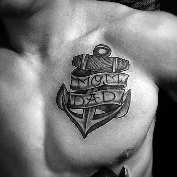 Chest tattoo of an anchor with ribbons elegantly inscribed with "MOM" and "DAD"