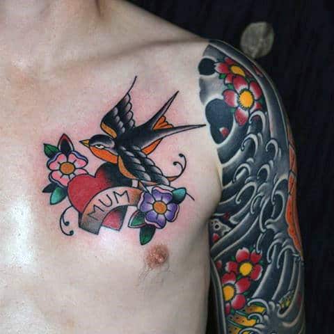 Swallow and heart with "Mum" chest tattoo, colorful sleeve tattoo on right arm with flowers