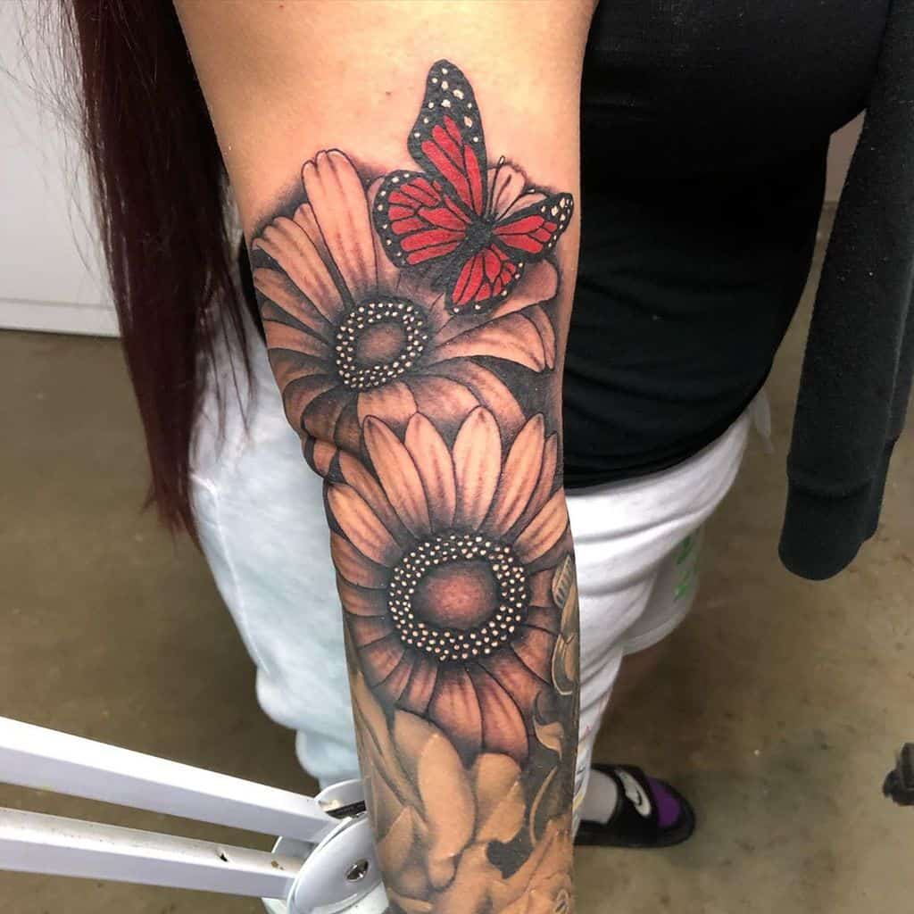Forearm tattoo realistic color monarch butterfly and daisy