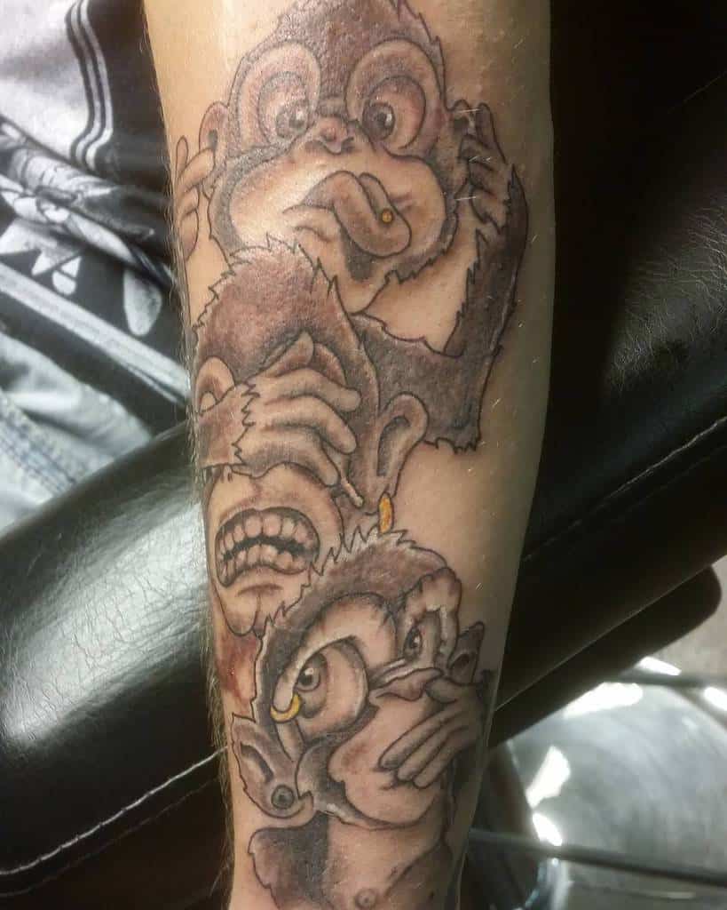 Tattoo of three monkeys on an arm: one covering eyes, another covering ears, and the last covering mouth
