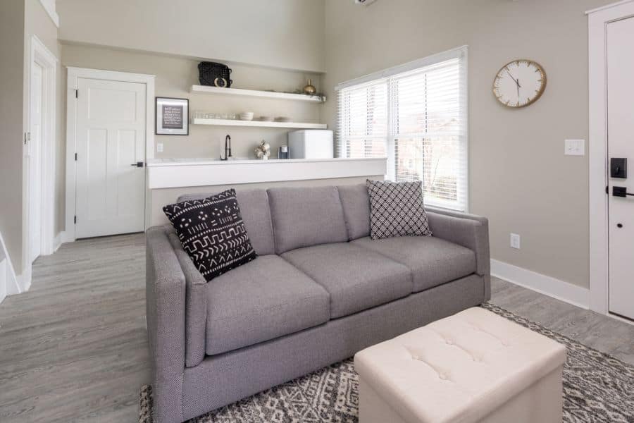 small apartment open plan kitchen and living room with gray sofa