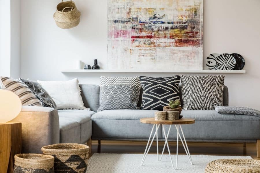 boho living room with gray l-shape sofa and woven basket decor