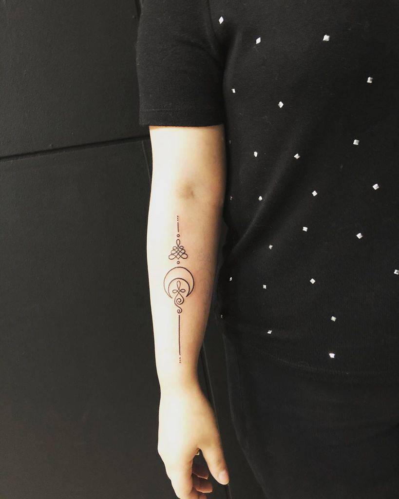 Unalome tattoo with a crescent moon on the forearm, symbolizing spiritual growth, balance, and the journey toward enlightenment.