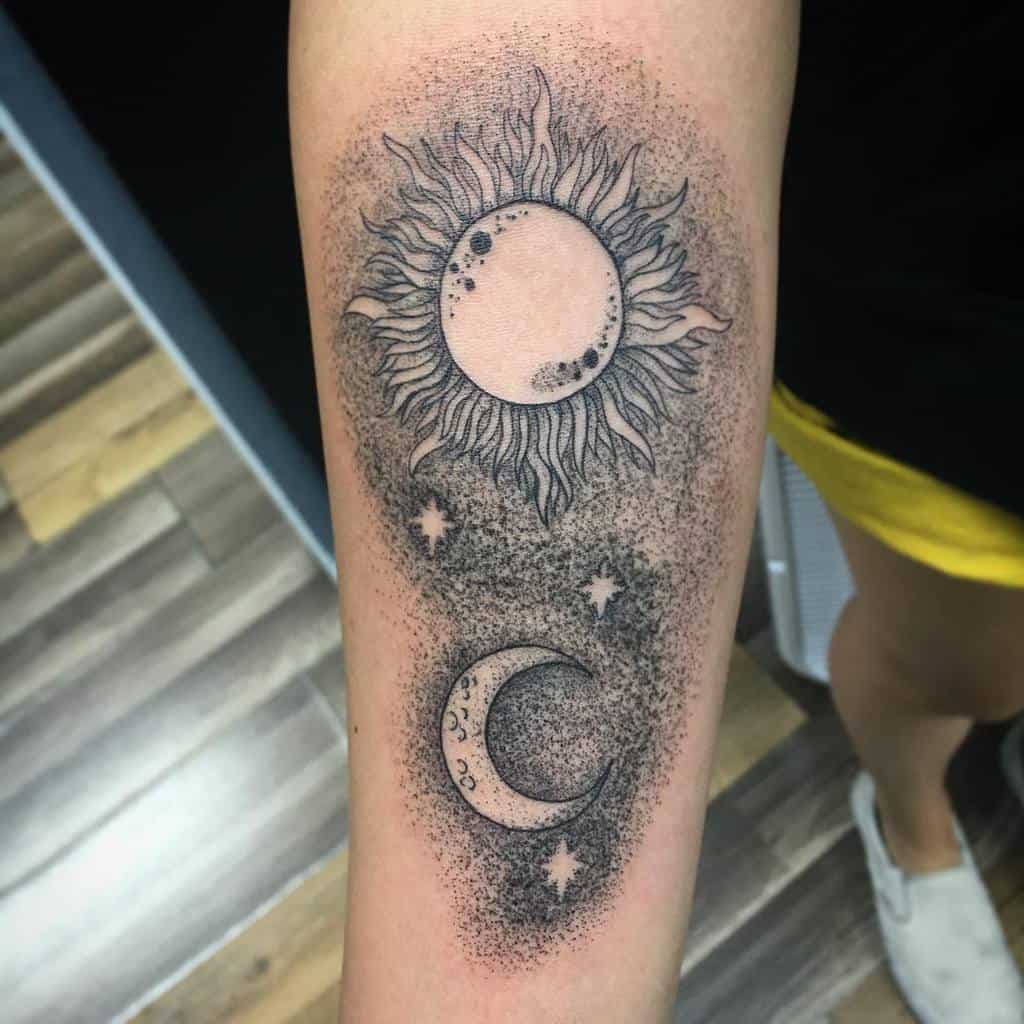 Forearm tattoo featuring a sun, moon, and stars in a dotwork style background