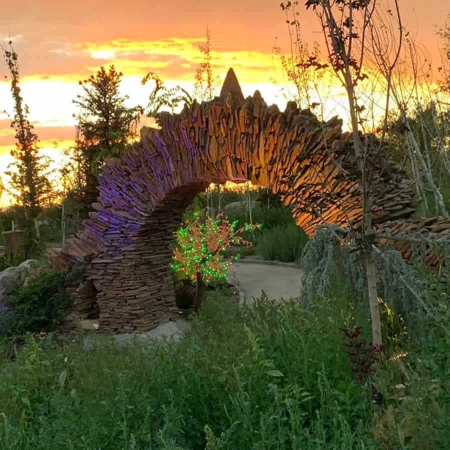 stone moo gate at sunset fairy lights in small tree