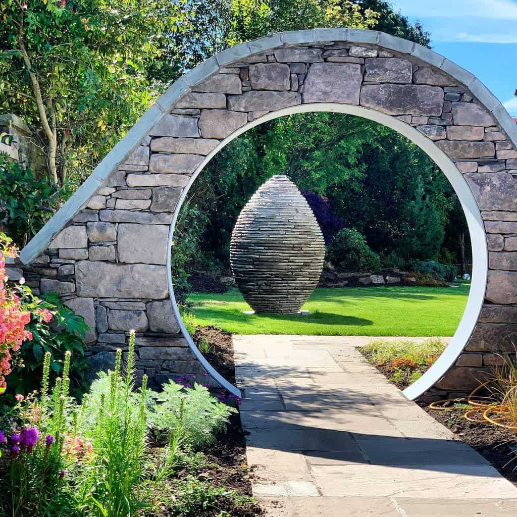 stone moon gate garden sculpture paved path
