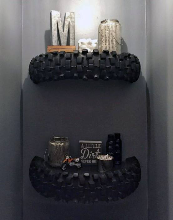 Decorative shelves made from tires hold jars, a small motorcycle model, and a sign saying "A Little Dirt Never Hurt