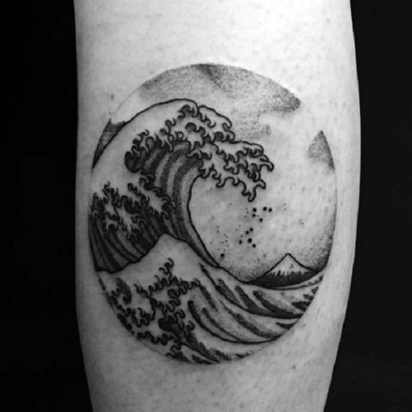 Black ink circular tattoo featuring a crashing wave, a distant mountain, and fine dot shading, inspired by Japanese art for a bold yet elegant design.
