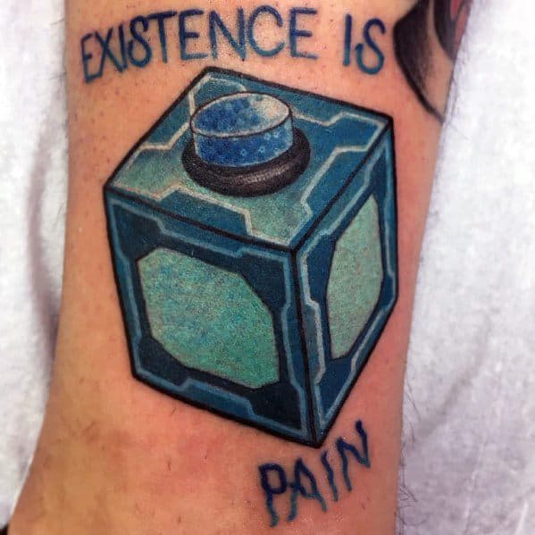 Tattoo of a Meeseeks Box from Rick and Morty with the phrase 'Existence is Pain' written above and below in blue lettering.