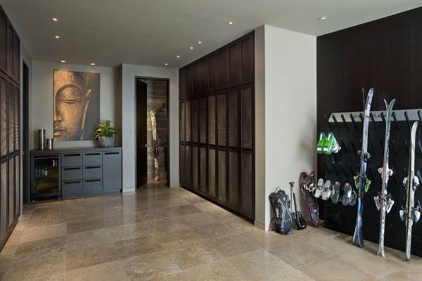 large mudroom with tile floor and ski equipment