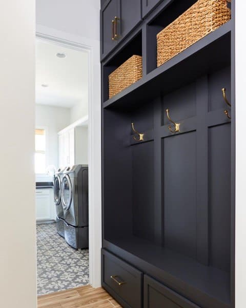 black cabinet with hooks in mudroom