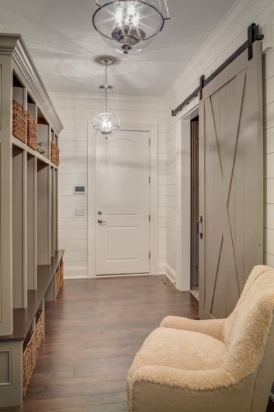 gray cabinet mudroom with sliding barn door