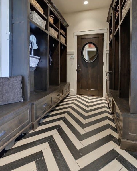 stained wood cabinet mudroom with subway tile flooring